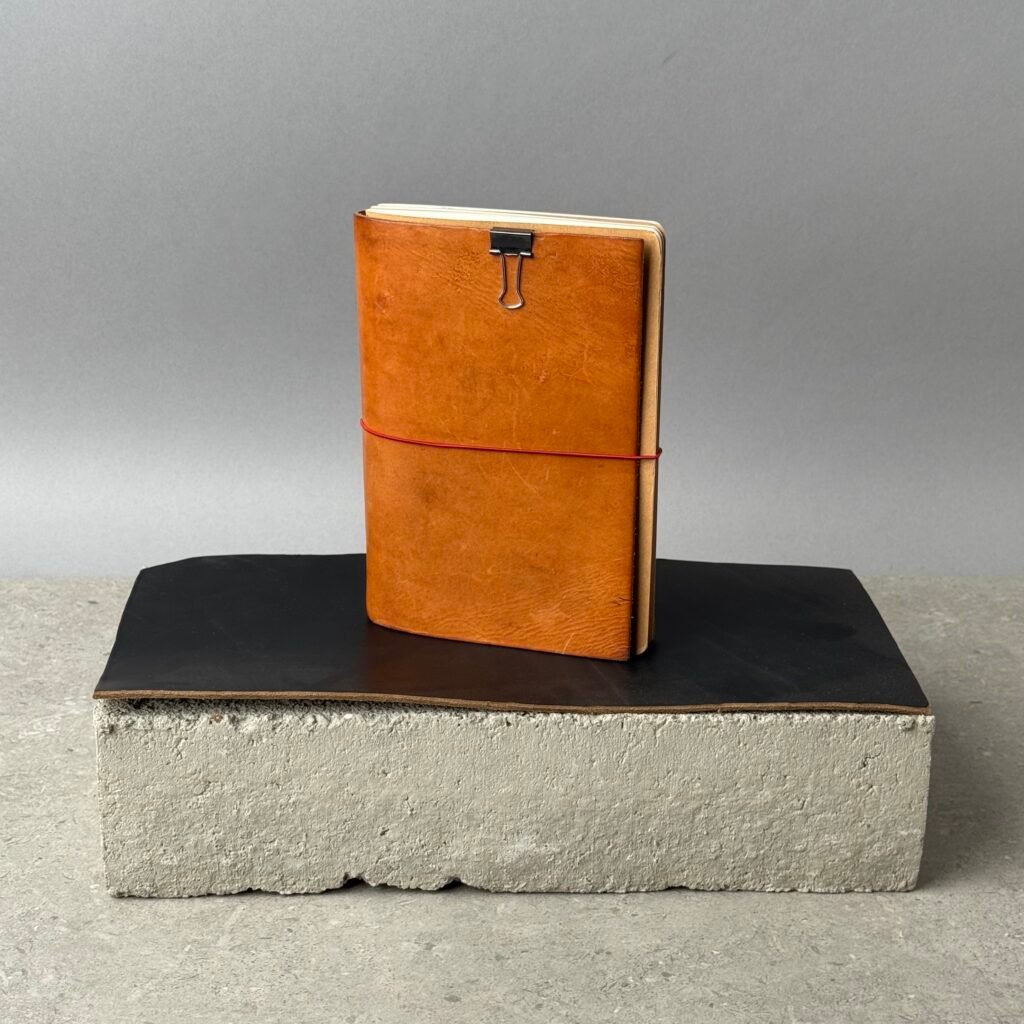 Paper Republic Grand Voyageur XL leather journal cover in cognac with notebook insert and brass clip on minimalist display